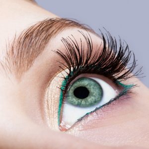Closeup shot of female face makeup with pistachio colour eye and green eyeliner